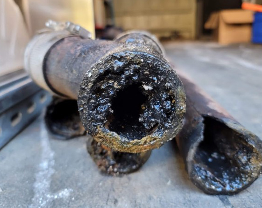 Old cast iron drain pipe clogged with heavy internal buildup