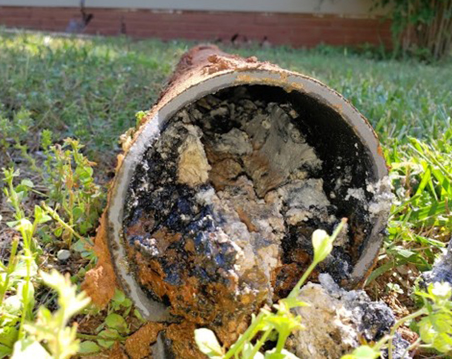 Sewer line repair trench with exposed underground pipe by Pathmaker Plumbing in Charlotte, NC.