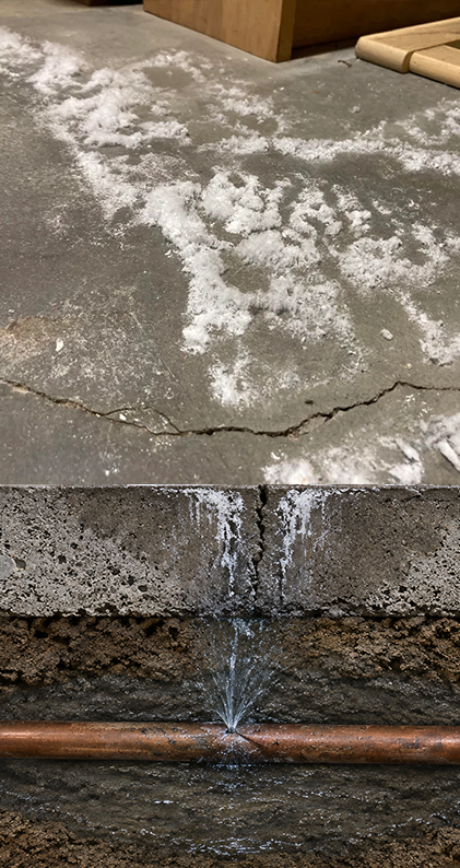 Slab leak causing efflorescence and cracking in a Highland Creek home
