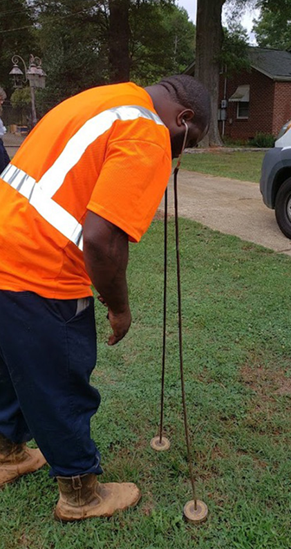 Water Line Leak Detection in Huntersville, NC Technician using acoustic leak detection equipment to locate a water line leak in Huntersville, NC